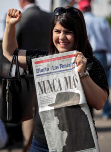 A woman gestures while holding a newspaper with a image of Cuban revolutionary leader Fidel Castro that reads in Spanish, "Never Again," a day after the announcement of the death of Castro, in the Little Havana district of Miami Nov. 27. Castro, who seized power in a 1959 revolution and governed Cuba until 2006, died Nov. 25 at the age of 90. (CNS photo/Javier Galeano, Reuters) See CASTRO-DEATH-POPE-WENSKI Nov. 27, 2016.