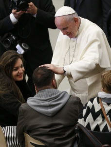Pope Francis greets a man while meeting the disabled during his general audience in Paul VI hall at the Vatican Nov. 30. (CNS photo/Paul Haring) See POPE-AUDIENCE-DEPARTED Nov. 30, 2016.