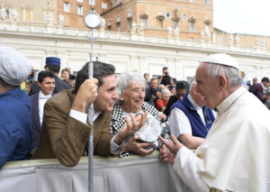 Pope Francis looks at a monstrance made from the tin of shanties from Nairobi, Kenya, during his general audience at the Vatican Oct. 19. The Vatican says 3.9 million pilgrims visited Rome during the Jubilee year. (CNS photo/L'Osservatore Romano, handout) See POPE-VISITORS Dec. 29, 2016.