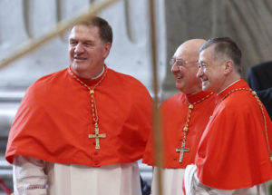New U.S. Cardinals Joseph W. Tobin of Indianapolis, Kevin J. Farrell, prefect of the new Vatican office for laity, family and life, and Blase J. Cupich of Chicago talk as they arrive for a consistory in St. Peter's Basilica at the Vatican Nov. 19. They were among 17 new cardinals created by Pope Francis. (CNS photo/Paul Haring) See VATICAN-LETTER-POPE-YEAR Dec. 1, 2106.