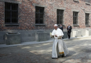 Pope Francis carries a candle as he visits the Auschwitz Nazi death camp in Oswiecim, Poland, July 29. The pope visited the camp while attending World Youth Day. (CNS photo/Paul Haring) See VATICAN-LETTER-POPE-YEAR Dec. 1, 2106.