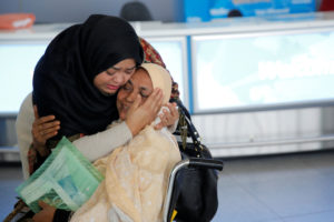 A woman greets her mother after she arrived from Dubai at John F. Kennedy International Airport in New York City Jan. 28. (CNS photo/Andrew Kelly, Reuters) See TRUMP-REFUGEES-REACTION Jan. 30, 2017.