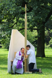 A priest hears confession from a World Youth Day pilgrim in 2016 at Park Jordana in Krakow, Poland. As the Catholic Church prepares for a meeting of the Synod of Bishops focused on youth, the pope wrote a letter to young people saying the church wants "to listen to your voice, your sensitivities and your faith, even your doubts and your criticism." (CNS photo/Bob Roller) See POPE-SYNOD-YOUTH Jan. 13, 2017.