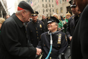 Detective Steven McDonald of the New York Police Department, who was shot and paralyzed in the line of duty in 1986, smiles as he is greeted by then Cardinal Edward M. Egan of New York in front of St. Patrick's Cathedral in New York City during the St. Patrick's Day Parade in 2013. McDonald died Jan. 10 at a Long Island hospital at age 59. (CNS photo/Gregory A. Shemitz) See OBIT-MCDONALD Jan. 11, 2017.