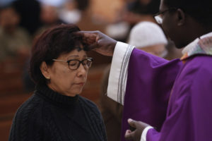 Ashes are distributed at St. Helen Church in Glendale, Arizona, in this 2016 file photo.  Ash Wednesday -- March 1 this year in the Western church calendar -- marks the start of Lent, a season of sacrifice, prayer and charity. (CNS photo/Nancy Wiechec)