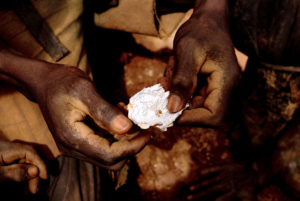A Congolese mine worker shows a small piece of gold found in 2009 after water processing in Chudja. Church leaders say telling companies they no longer had to disclose whether their firms use "conflict minerals" would be a bad move. (CNS photo/Marc Hofer, EPA) See CONFLICT-MINERALS-POTENTIAL-ORDER Feb. 17, 2017.