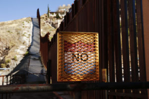 A "No Trespassing" sign is situated along the steel bollard border fence in Nogales, Ariz., Feb. 19. (CNS photo/Nancy Wiechec)
