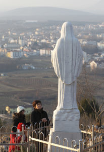 Pilgrims pray at a statue of Mary on Apparition Hill in Medjugorje, Bosnia-Herzegovina, in this Feb. 26, 2011, file photo. Pope Francis has appointed Archbishop Henryk Hoser of Warsaw-Praga, Poland, as his special envoy to Medjugorje, the site of alleged Marian apparitions. A Vatican statement said his role would be to study the pastoral situation in Medjugorje. (CNS photo/Paul Haring) See POPE-MEDJURORGE-PASTORAL Feb. 13, 2017.