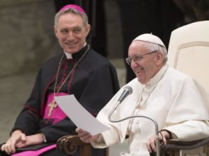 Pope Francis smiles during his general audience in Paul VI hall Feb. 15  at the Vatican. Also pictured is Archbishop Georg Ganswein, prefect of the papal household.(CNS photo/Claudio Peri, EPA) See POPE-AUDIENCE-HOPE Feb. 15, 2017.