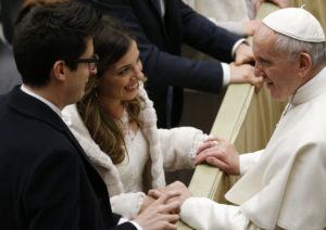 Pope Francis greets newlyweds Marco and Stefania Damiani of Rome during his general audience in Paul VI hall at the Vatican Feb. 8. Each week dozens of newlyweds from around the world meet the pope and receive a special papal blessing at the general audience. (CNS photo/Paul Haring) See VATICAN-LETTER-NEWLYWEDS Feb. 9, 2017.