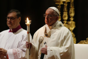 Pope Francis holds a candle as he celebrates Mass marking the feast of the Presentation of the Lord in St. Peter's Basilica at the Vatican Feb. 2. The Mass also marked the World Day for Consecrated Life. (CNS photo/Paul Haring) See POPE-PRESENTATION-RELIGIOUS Feb. 2, 2017.