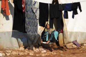 A Syrian woman washes clothes inside her tent Jan. 19 at Syria's Bab Al-Salam camp for displaced in Azaz, near the Turkish border. When it comes to helping the poor, the marginalized and refugees, Pope Francis urged Catholics not to mimic the "Mannequin Challenge" by just looking on, frozen and immobile. (CNS photo/Khalil Ashawi, Reuters) See POPE-PRAYER-REFUGEES Feb. 2, 2017