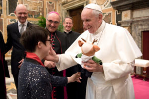 Pope receives a stuffed animal from a participant in the Special Olympics during a meeting Feb. 16 at the Vatican. The athletes and organizers were at the Vatican to promote the Special Olympics World Winter Games, which will be held in Austria March 14-25. (CNS photo/L'Osservatore Romano, handout) See POPE-SPECIAL-OLYMPICS Feb. 16, 2017.