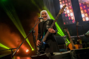 Sister Teresa of the pop band Siervas is seen playing her bass guitar during an undated concert. Sister Teresa and 11 other women, who are members of the Servants of the Plan of God, have taken their inspirational music to other countries but also do social service work in Peru. (CNS photo/courtesy Lukas Isaac) See PERU-SINGING-SISTERS Feb. 14, 2017.