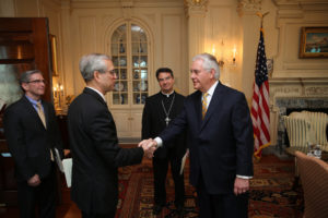 Bishop Oscar Cantu of Las Cruces, N.M., center, looks on as Stephen Colecchi, director of the Office of International Justice and Peace at the U.S. Conference of Catholic Bishops, is greeted by U.S. Secretary of State Rex Tillerson during a March 23 meeting at the  State Department in Washington. At far left is Stephen Hilbert, international policy adviser with the USCCB. (CNS photo/Bob Roller) See story to come.