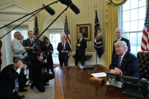 U.S. President Donald Trump talks to journalists in the Oval Office at the White House March 24 after the American Health Care Act was pulled before a vote. Now that lawmakers have withdrawn the bill, Congress must "seize this moment to create a new spirit of bipartisanship" and make "necessary reforms" in existing health care law to address access, affordability, life and conscience, said three U.S. bishops' committee chairmen. (CNS photo/Carlos Barria, Reuters) See BISHOPS-HEALTH-CARE-REFORM March 31, 2017.