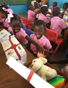 Children in Les Cayes, Haiti, open presents March 22 that they received through the Box of Joy program of Cross Catholic Outreach, a Florida based relief and development agency. (CNS photo/courtesy of Cross Catholic Outreach) See BOX-OF-JOY-CHILDREN March 30, 2017.