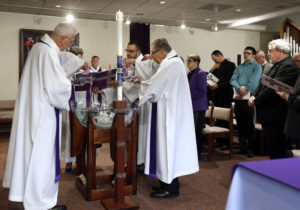 The Rev. Lowell Almen and retired Auxiliary Bishop Denis J. Madden of Baltimore auxiliary, who is co-chair of the U.S. Lutheran-Catholic Dialogue, fill a vessel with water for blessing during a March 2 prayer service in Chicago. Catholic and Lutheran bishops gathered to commemorate the 500th anniversary of the Reformation and to release a joint statement on the two churches' ongoing relationship. (CNS photo/Karen Callaway, Chicago Catholic) See CATHOLICS-LUTHERANS-REFORMATION March 7, 2017.