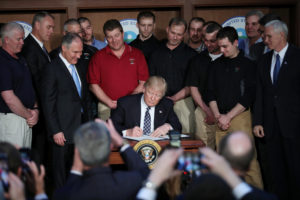U.S. President Donald Trump signs an executive order titled "Energy Independence" during a March 28 event at the Environmental Protection Agency headquarters in Washington. The order eliminates Obama-era climate change regulations and calls for a review of President Barack Obama's Clean Power Plan. (CNS photo/Carlos Barria, Reuters) See CLEAN-POWER-TRUMP-ACTION March 28, 2017.