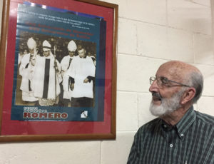 Father Salvador Carranza looks at a poster on the wall of his parish church in Santa Tecla, El Salvador, Jan. 28, which features Father Rutilio Grande on the right, a Jesuit priest killed 40 years ago March 12. Jesuit Father Carranza worked on a team of missionaries from 1972 until Father Grande was assassinated in 1977 for evangelizing the country's rural communities and speaking out against the meager wages and other social conditions that affected El Salvador's poor. (CNS photo/Rhina Guidos) See GRANDE-SAINT-JESUIT March 8, 2017.