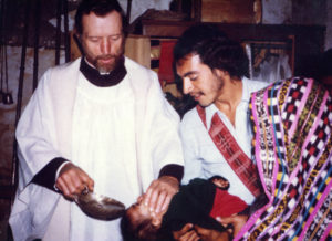 Father Stanley Rother, a priest of the Oklahoma City Archdiocese who was brutally murdered in 1981 in the Guatemalan village where he ministered to the poor, is shown baptizing a child in this undated photo. The Archdiocese of Oklahoma City announced the North American priest will be beatified Sept. 23 in Oklahoma. (CNS) See BEATIFY-ROTHER-OKLAHOMA March 13, 2017.