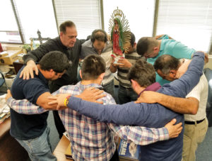 Father Jose E. Hoyos, director of the Spanish Apostolate Office of the Diocese of Arlington, Va., prays with a group of Hispanic leaders in his office Feb. 24. (CNS photo/Mary Stachyra Lopez, Arlington Catholic Herald) See IMMIGRATION-CHURCH-HELP March 6, 2017.
