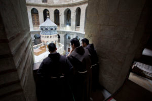 Men religious watch a ceremony in Jerusalem's Old City marking the end of restoration work on the site of Jesus' tomb at the Church of the Holy Sepulcher March 22. (CNS photo/Sebastian Scheiner, Reuters) See JERUSALEM-EDICULE-REOPEN March 22, 2017.
