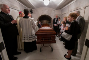 Baltimore Archbishop William E. Lori gives the final blessing over the casket of Cardinal William H. Keeler, retired archbishop of Baltimore, March 28 in the crypt of the Basilica of the Shrine of the Assumption of the Blessed Virgin Mary in Baltimore. Cardinal Keeler, Baltimore's 14th archbishop, died March 23 at age 86. (CNS photo/Kevin J. Parks, Catholic Review) See KEELER-FUNERAL March 29, 2017.