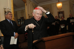 Cardinal William H. Keeler, retired archbishop of Baltimore, places a zucchetto on his head as he prepares to offer the opening prayer during a prayer service for Catholic and Jewish leaders hosted by New York Archbishop Timothy M. Dolan at his residence in New York May 12, 2009. Cardinal Keeler died March 23. He was 86. (CNS photo/Gregory A. Shemitz) See OBIT-KEELER March 23, 2017.
