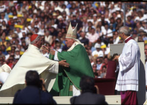 Cardinal William H. Keeler of Baltimore embraces St. John Paul II at Oriole Park at Camden Yards during the pope's historic 1995 visit to Baltimore. Cardinal Keeler, who retired in 2007, died March 23 at age 86. (CNS photo/The Catholic Review) See OBIT-KEELER March 23, 2017.