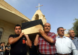Iraqi men carry the coffin of a Christian man, who was killed by unknown gunmen, during his funeral in 2011 in Kirkuk. A year after the U.S. genocide declaration, the Knights of Columbus is continuing its humanitarian support for persecuted Christian communities in the region by contributing nearly $2 million in new assistance. (CNS photo/Khalil Al-A'nei, EPA) See KNIGHTS-PRAYERS-PERSECUTED March 15, 2017.