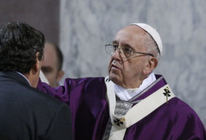 Pope Francis places ashes on a man's forehead during Ash Wednesday Mass at the Basilica of Santa Sabina in Rome March 1. (CNS photo/Paul Haring) See POPE-ASHES March 1, 2017.