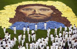 An image of Jesus is seen as youths perform for Pope Francis during his meeting with confirmation candidates at San Siro stadium in Milan March 25. (CNS photo/Alessandro Garofalo, Reuters) See POPE-MILAN-MASS-YOUTH March 25, 2017.