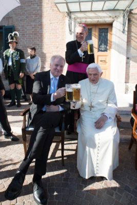 Retired Pope Benedict XVI raises a glass of beer with Bavarian Prime Minister Horst Seehofer during the German pontiff's 90th birthday celebration April 17 at the Vatican. Also pictured is Archbishop Georg Ganswein, prefect of the papal household, in rear. The pope's birthday was the previous day. (CNS photo/L'Osservatore Romano)