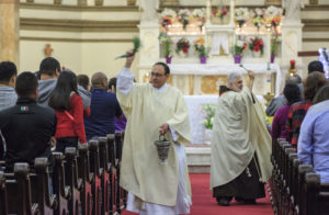 Father Todd Carpenter and Deacon Angel Rivera bless the congregation with holy water during the  Easter Vigil in 2016 at St. Paul Church in Wilmington, Del. The Roman Missal, which spells out specifics of how the vigil is to be celebrated, describes it as the "mother of all vigils." (CNS photo/Octavio Duran) See EASTER-VIGIL-MASS April 7, 2017.