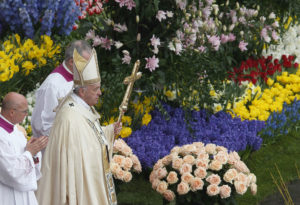 Pope Francis walks past flowers as he celebrates Easter Mass in St. Peter's Square at the Vatican April 16. (CNS photo/Paul Haring) See POPE-EASTER-ROUNDUP April 16, 2017.