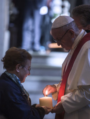 Pope Francis lights a candle during a prayer service at the Basilica of St. Bartholomew in Rome April 22. The service was in memory of Christians killed for their faith in the 20th and 21st centuries. (CNS photo/Maria Grazia Picciarella, pool) See POPE-MODERN-MARTYRS April 22, 2017.