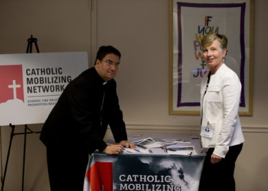 Bishop Oscar Cantu of Las Cruces, N.M., and Karen Clifton, executive director of the Catholic Mobilizing Network against the Death Penalty, pose for a photo while signing pledges at the U.S. Conference of Catholic Bishops building in Washington May 9. (CNS photo/Tyler Orsburn) See DEATH-PENALTY-PLEDGE May 9, 2017.