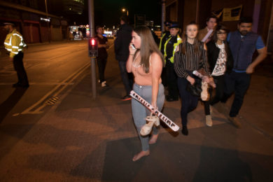 Concertgoers react after fleeing Manchester Arena in England where U.S. singer Ariana Grande had been performing May 22. At least 22 people, including children, were killed and dozens wounded after an explosion at the concert venue. Authorities said it was Britain's deadliest case of terrorism since 2005. (CNS photo/Jon Super, Reuters) See MANCHESTER-ARENA-REACT May 23, 2017.