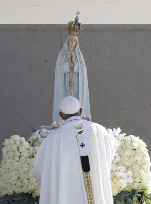 Pope Francis uses incense as he venerates a statue of Our Lady of Fatima during the canonization Mass of Sts. Francisco and Jacinta Marto, two of the three Fatima seers, at the Shrine of Our Lady of Fatima in Portugal, May 13. The Mass marked the 100th anniversary of the Fatima Marian apparitions, which began on May 13, 1917. (CNS photo/Paul Haring) See POPE-FATIMA-CANONIZATION May 13, 2017.