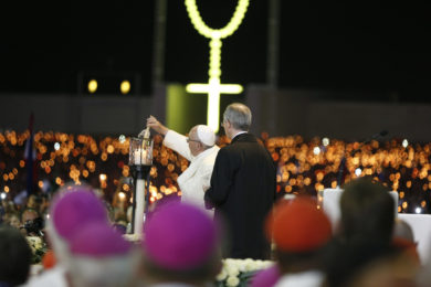 Pope Francis lights a candle as he leads a vigil in the Little Chapel of the Apparitions at the Shrine of Our Lady of Fatima in Portugal May 12. The pope was making a two-day visit to Fatima to commemorate the 100th anniversary of the Marian apparitions and to canonize two of the young seers. (CNS photo/Paul Haring) See POPE-FATIMA-VIGIL May 12, 2017.