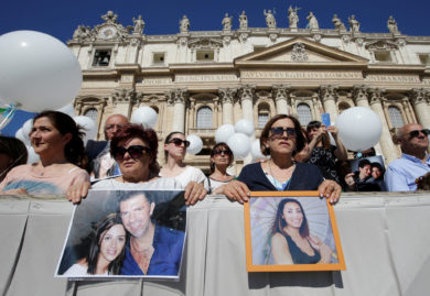 Relatives of the victims of the avalanche that hit Hotel Rigopiano in Farindola, Italy, hold portraits of family members as Pope Francis leads his general audience in St. Peter's Square May 17 at the Vatican. (CNS photo/Max Rossi, Reuters) See POPE-AUDIENCE-MAGDALENE May 17, 2017.