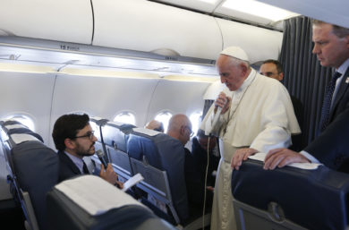 Pope Francis listens to a question from Joshua McElwee of the National Catholic Reporter as he speaks with journalists aboard his flight from Portugal to Rome May 13. The pope made a two-day visit to Fatima to commemorate the 100th anniversary of the Marian apparitions and to canonize Sts. Francisco and Jacinta Marto, two of the young seers. (CNS photo/Paul Haring) See POPE-FATIMA-FLIGHT May 13, 2017.