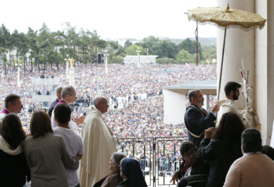 Pope Francis walks in a procession as he blesses the sick with the Eucharist at the conclusion of the canonization Mass of Sts. Francisco and Jacinta Marto, two of the three Fatima seers, at the Shrine of Our Lady of Fatima in Portugal May 13. The Mass marked the 100th anniversary of the Fatima Marian apparitions, which began on May 13, 1917. (CNS photo/Paul Haring) See POPE-FATIMA-CANONIZATION May 13, 2017.
