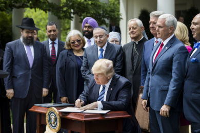 President Donald Trump signs his Executive Order on Promoting Free Speech and Religious Liberty during a National Day of Prayer event at the White House in Washington May 4. (CNS photo/Jim Lo Scalzo, EPA) See RELIGIOUS-FREEDOM-EXECUTIVE-ORDER May 4, 2017.