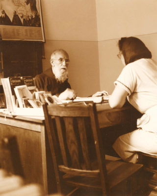 Father Solanus Casey, a Capuchin priest in Detroit, Mich.,  is seen talking to a woman in this 1954 file photo. During his lifetime, countless men, women and young people came to him seeking wisdom, counsel and aid. (CNS photo/The Michigan Catholic) See DETROIT-CASEY-REMEMBER May 5, 2017.