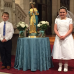 Second-graders from Mater Dolorosa School in Holyoke participate in the May Crowning Ceremony at Our Lady of the Cross Parish.