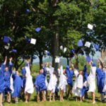 Eighth grade students from Mater Dolorosa School in Holyoke do the traditional hat toss after their graduation ceremony.