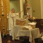 St. Anthony bread and items donated for families in need are blessed at Our Lady of Mt. Carmel Parish in Springfield.