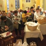 Parishioners at Our Lady of Mt. Carmel Parish in Springfield donate to the local soup kitchen and prepare to bring home their blessed St. Anthony bread.